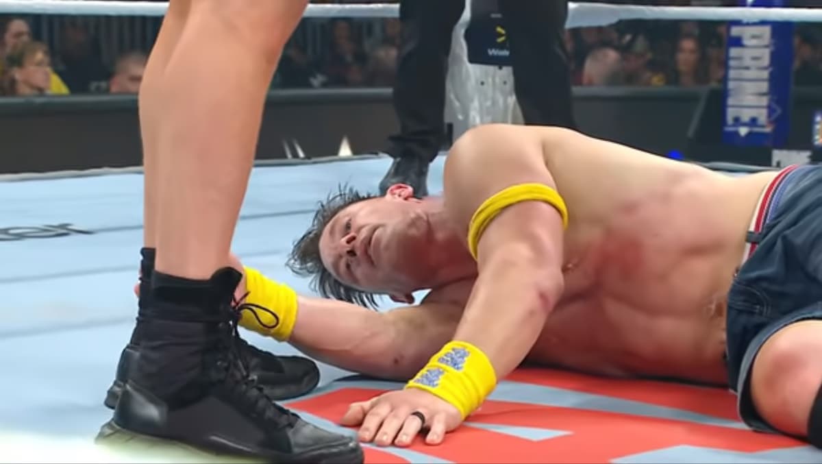 John Cena looking tired while lying in the ring