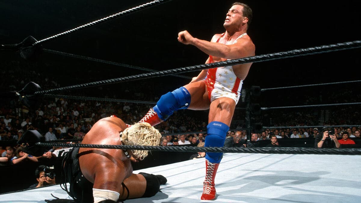 Rikishi lying in the corner being kicked by Kurt Angle at WWE King of the Ring 2000