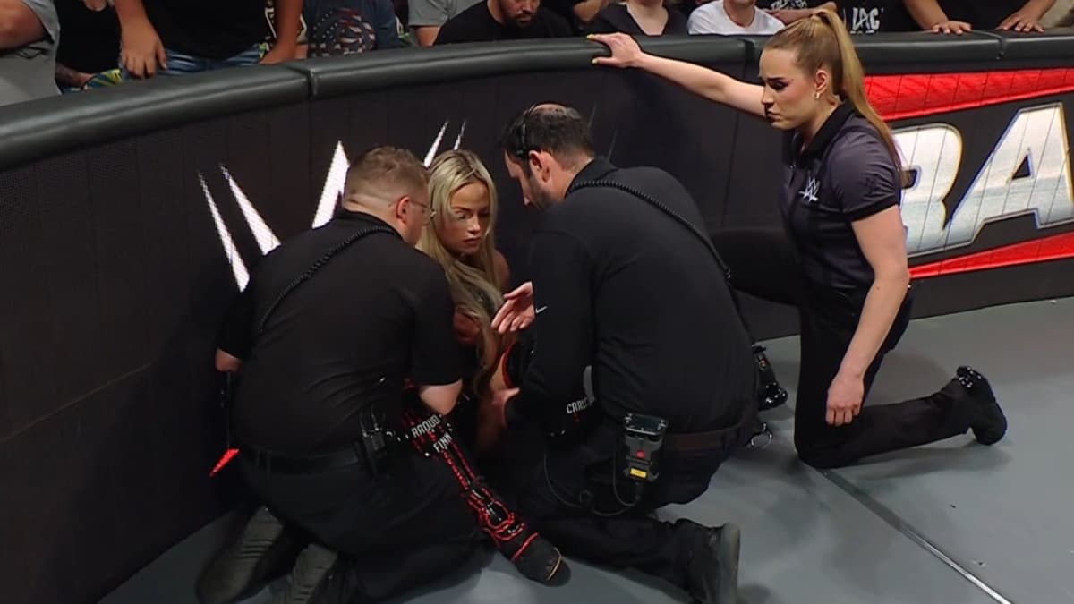 Medical personnel and a referee check on WWE star Liv Morgan after she suffered an injury during a match on Raw