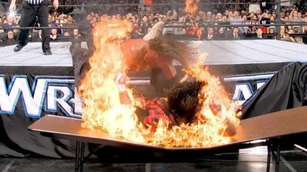 Edge Mick Foley Flaming Table WrestleMania 22.jpg