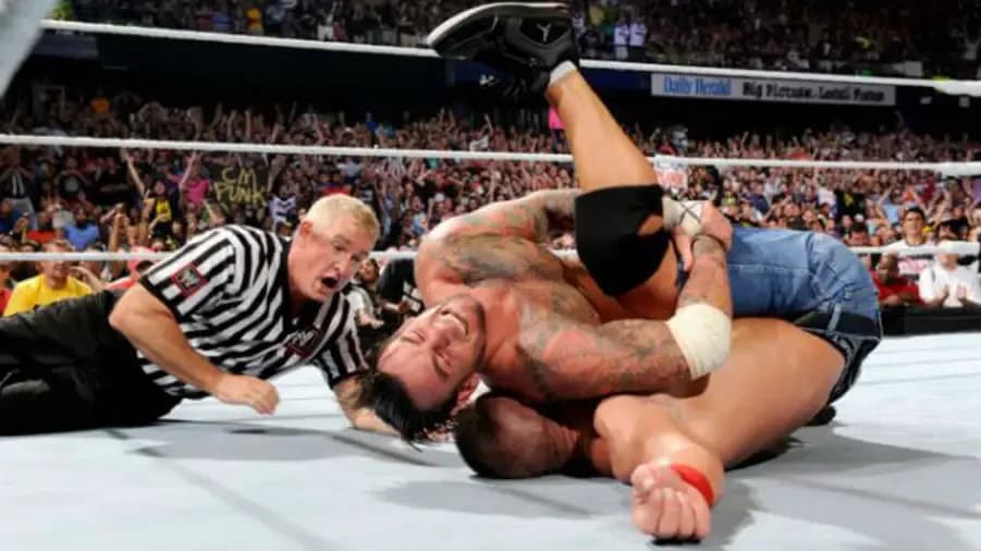 https://cultaholic.com/files/images/7114ab580983a7f393fe2f43c7a06616163c8b65-cm-punk-john-cena-money-in-the-bank-2011.jpg